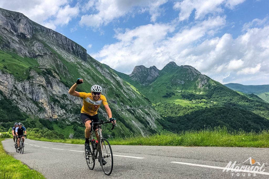 Cyclist punching air on Col du Soulour cycling Raid Pyrenees with Marmot Tours guided road cycling tours