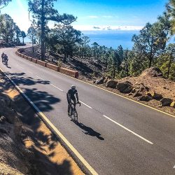 Cyclist climb above clouds beneath blue sky on fully supported road cycling holiday on Tenerife with Marmot Tours