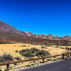 Cyclist on smooth road beneath blue sky next to Mt Teide on Tenerife road cycling holiday with Marmot Tours