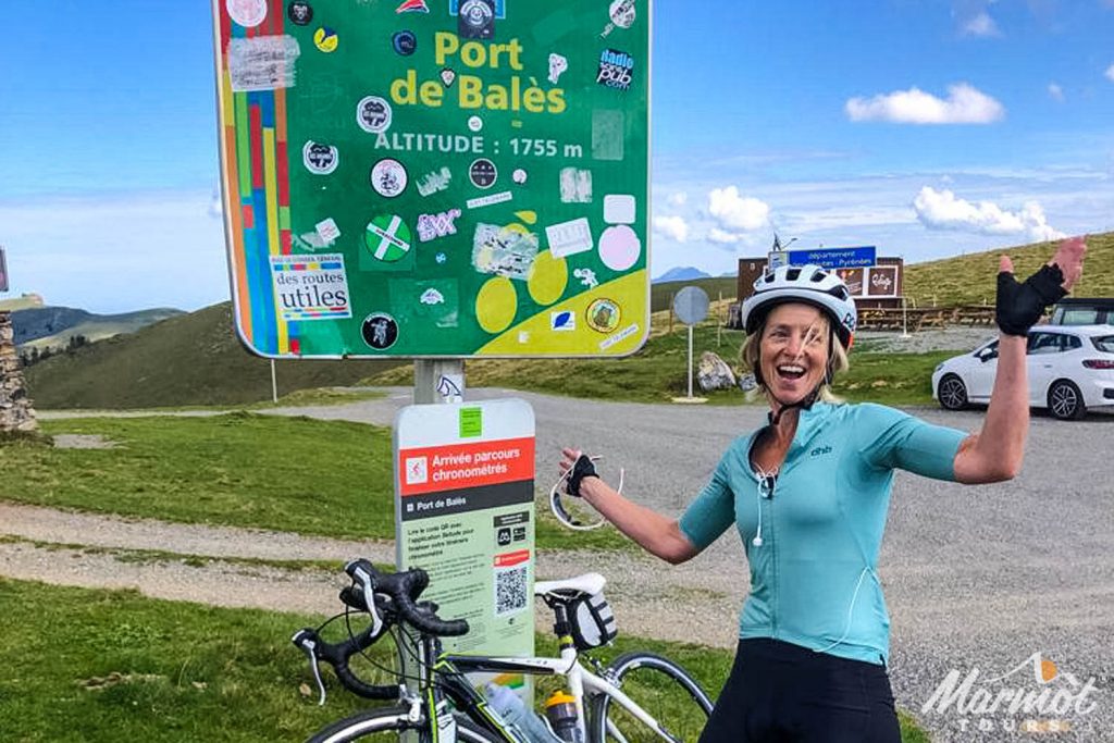 Emma Tiptaft Marmot Tours cycling guide cheering at Port de Bales cycling climb Pyrenees