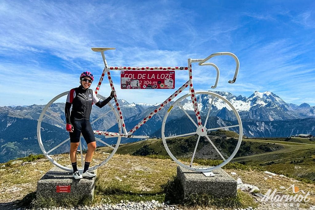 Cyclist smiling at Col de la Loze cycling climb Meribel on Marmot Tours full support cycling holiday northern French Alps