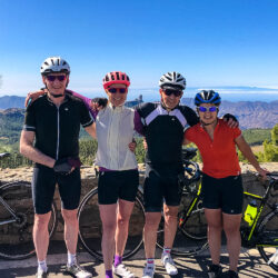 Group of cyclists pose for photo with Roque Nublo backdrop on Gran Canaria full support cycling holiday with Marmot Tours