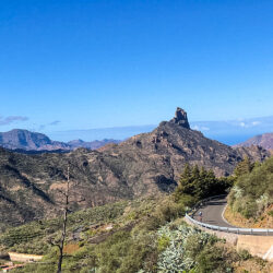 Cyclist climbing with Roque Nublo backdrop on Gran Canaria full support cycling holiday with Marmot Tours