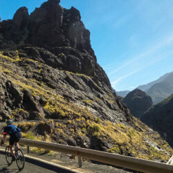 Cyclist riding through rocky ravine on guided full support Gran Canaria cycling tour with Marmot Tours