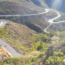 Cyclists descending bending road on Pico de las Nieves climb on Gran Canaria with Marmot Tours