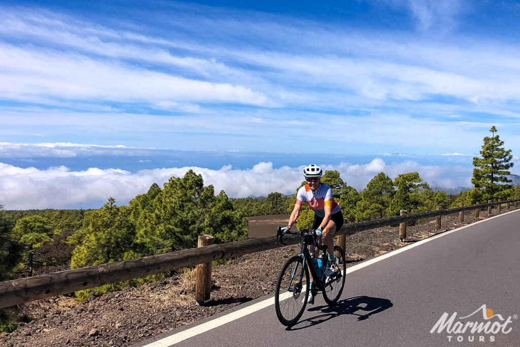Female cyclist smiling while cycling above the clouds on full support cycling holiday in Tenerife with Marmot Tours