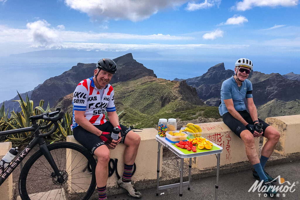 Pair of cyclists enjoying break with snacks and fruit on Marmot Tours full support road cycling holiday on Tenerife