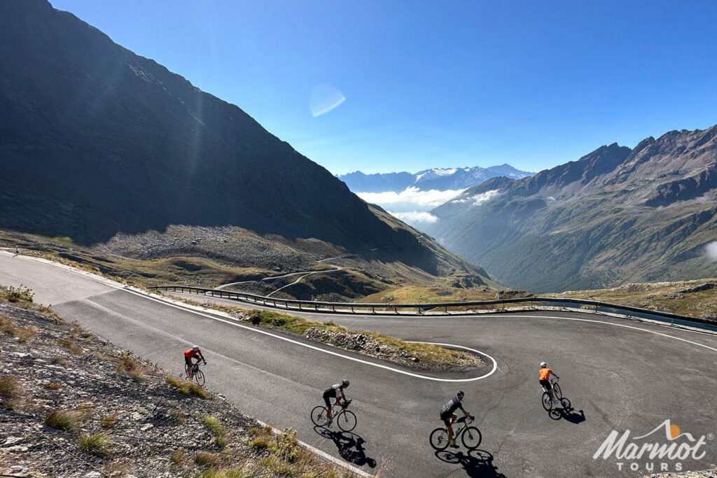 Group of cyclists descending mountain climb in the Italian Dolomites on Marmot Tours road cycling tours