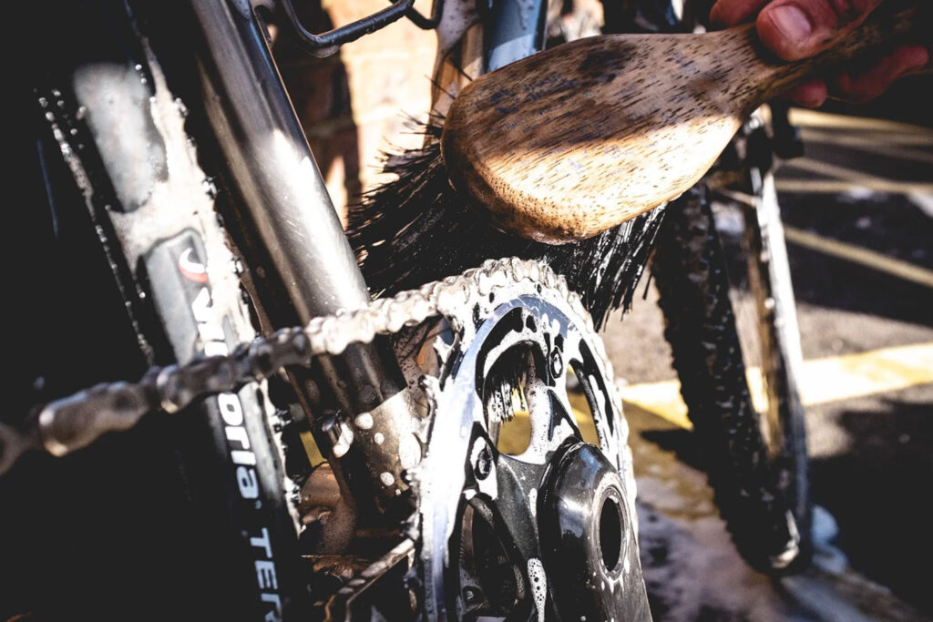 Close up of a dirty bike chain being cleaned