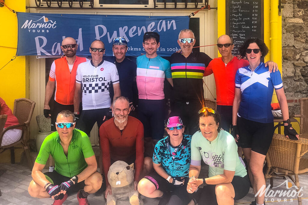 Group of cyclists celebrating at the finish of Raid Pyrenees on Marmot Tours guided road cycling holiday