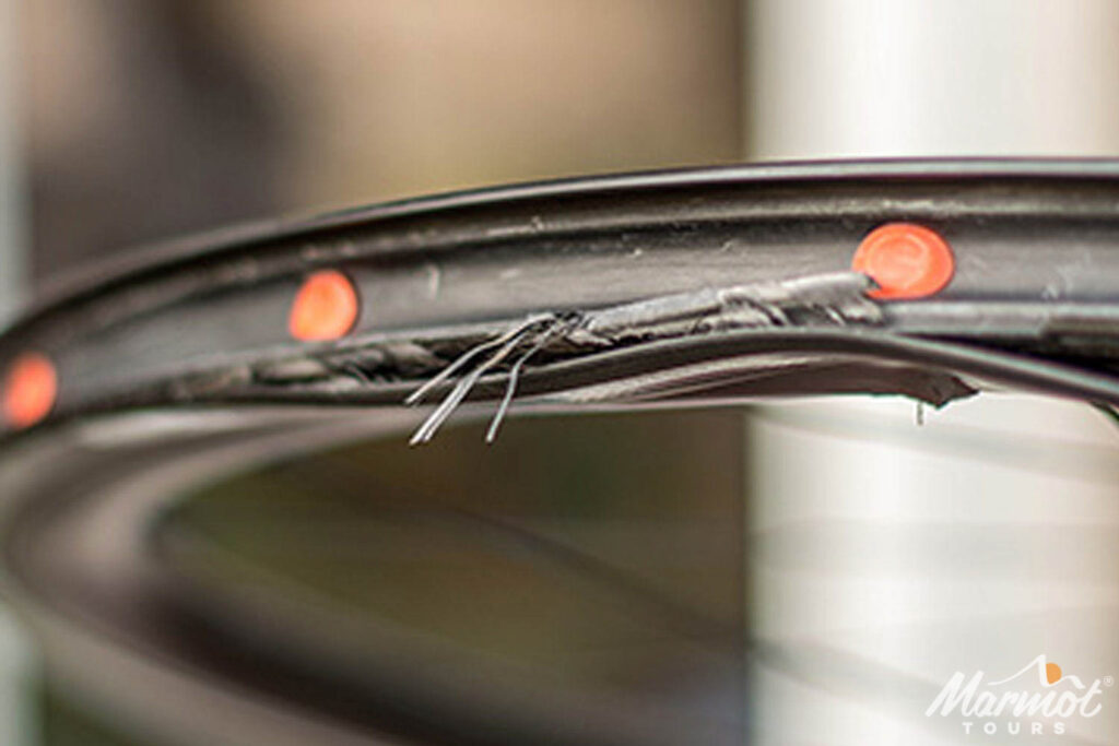 Close up of delaminated rim-brake carbon wheel on Marmot Tours guided road cycling