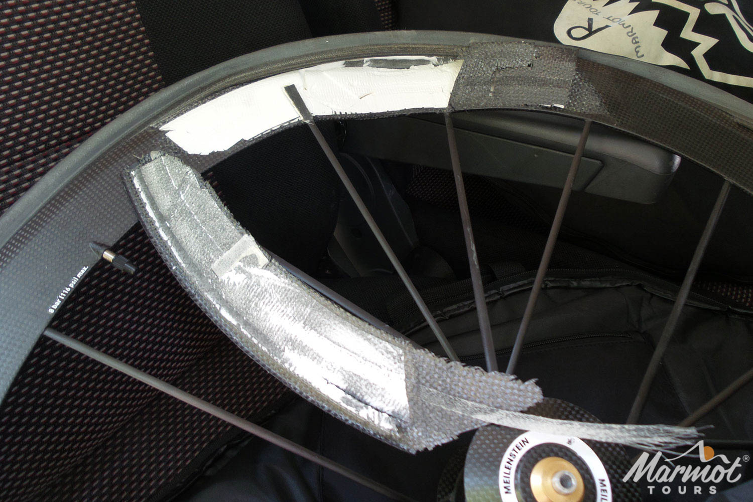 Delaminated rim-brake carbon wheel on Marmot Tours guided road cycling tour in