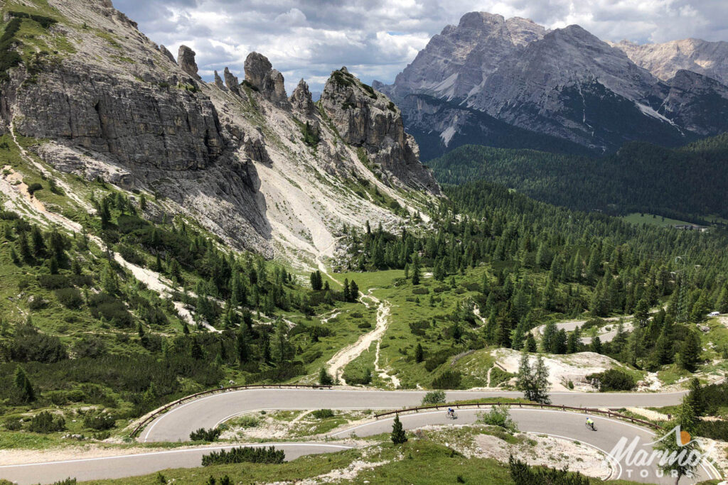 Cyclists descending hairpins of passo cello stelvio on marmot tours supported road cycling holiday Italian dolomites