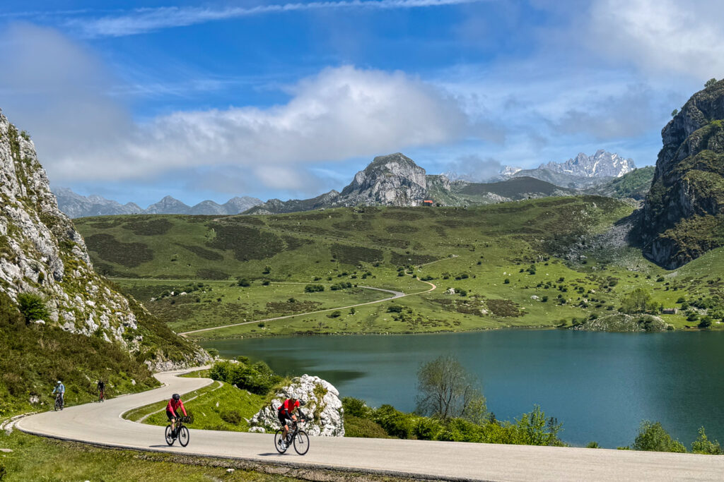 Cyclists climbing Passo di Gavia with lake and mountain backdrop on Marmot Tours guided road cycling holiday in Italian Dolomites