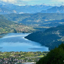 lake and mountains taken from menador climb on marmot tours guided road cycling tour monte grappa dolomites