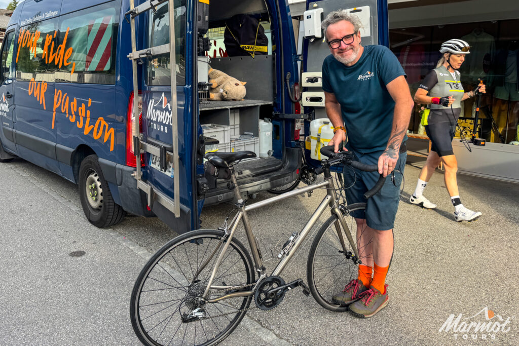 Marmot Tours guide Scot tares adjusting handlebars on hire bike